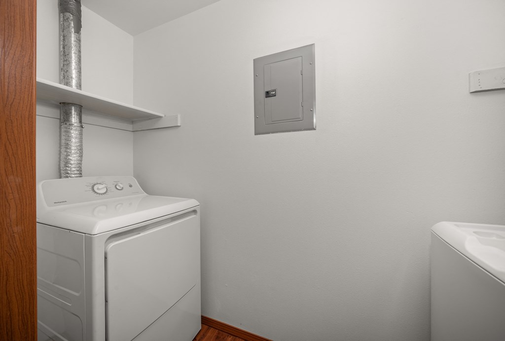 a white washer and dryer in a room with a white wall and a