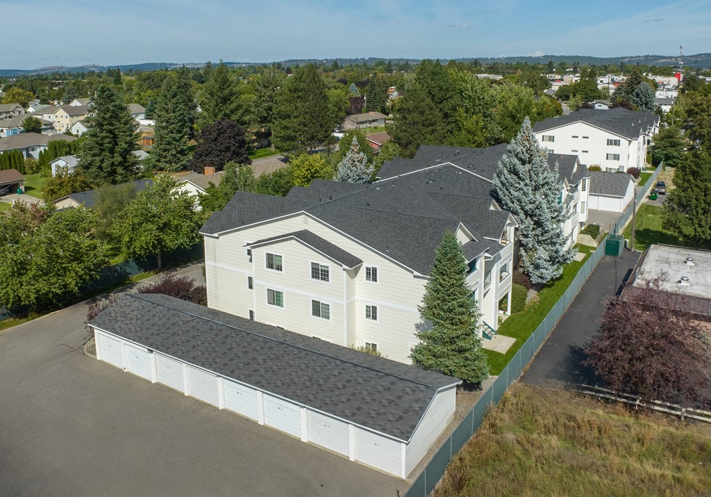 an aerial view of a white house with a gray roof