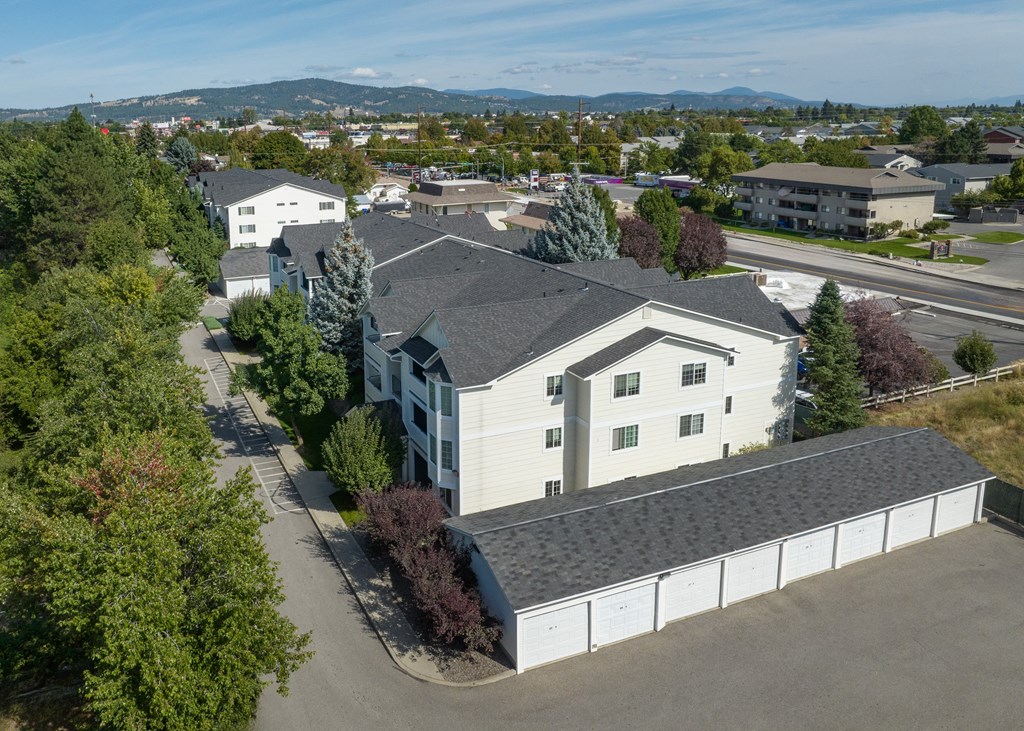 an aerial view of a white house with a gray roof