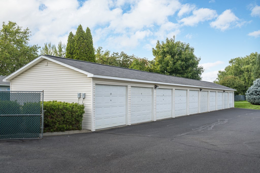 a large white garage with white doors and a roof