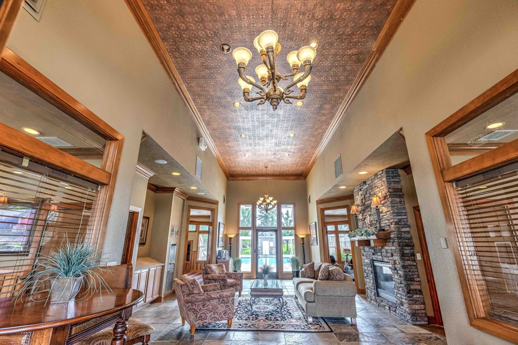 a large living room with a fireplace and a chandelier