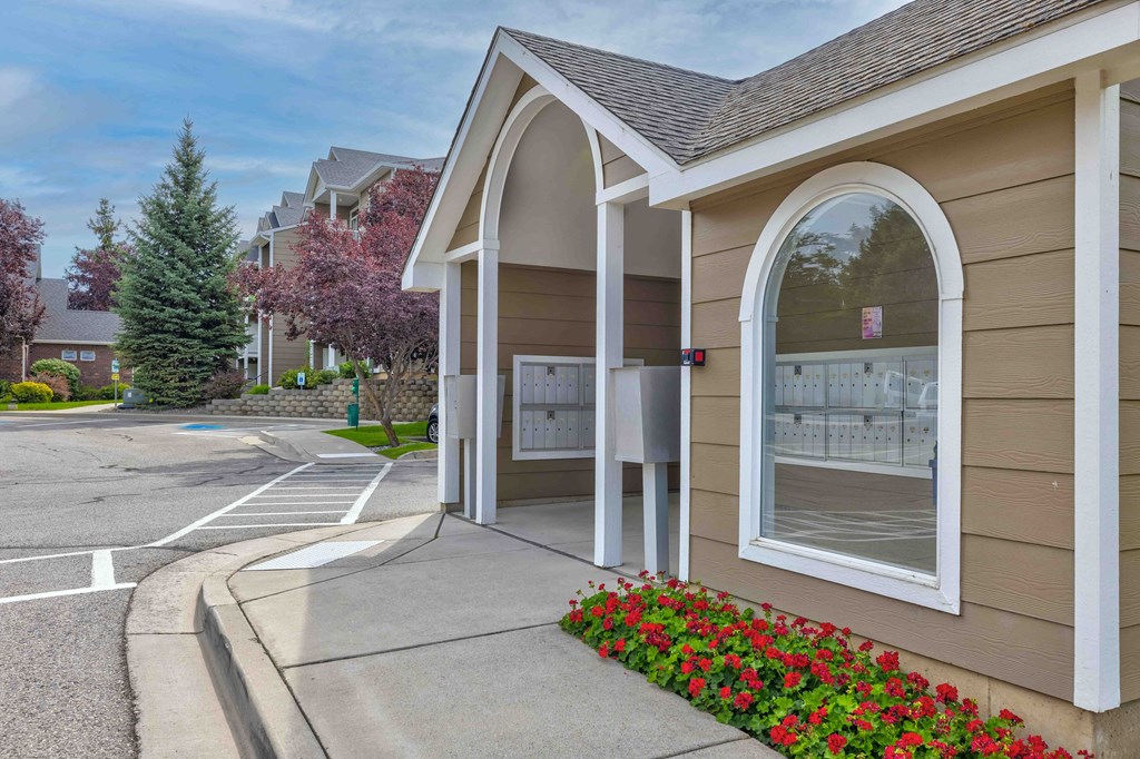 a building with a sidewalk and a parking lot