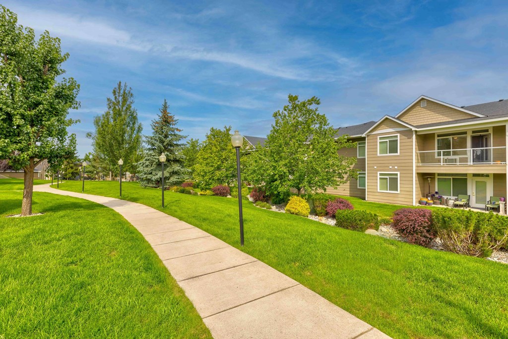 a sidewalk leading to a row of houses