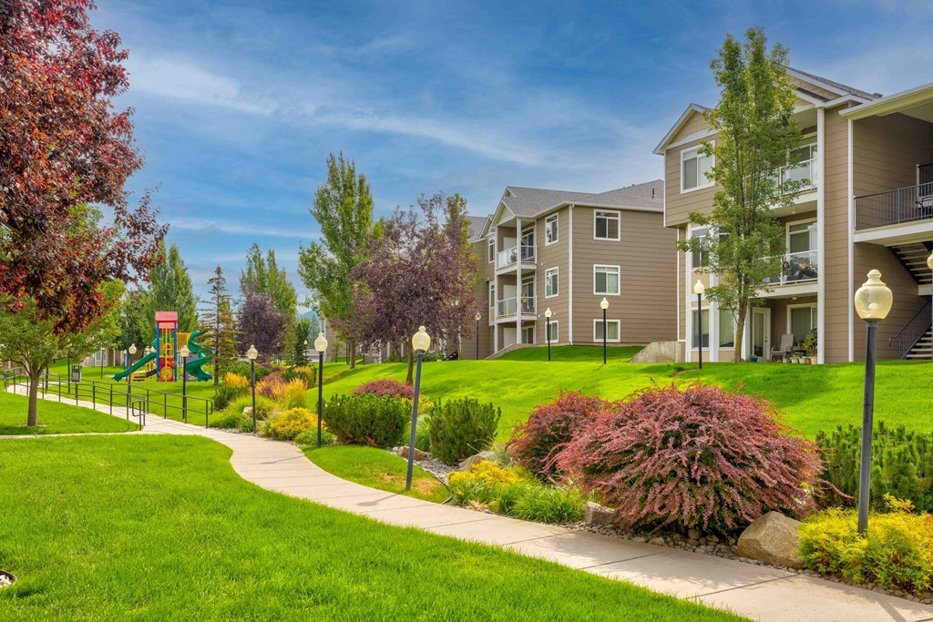 an exterior view of an apartment building and a sidewalk
