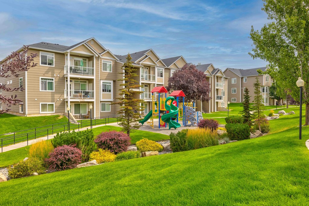 an outdoor playground in front of an apartment building