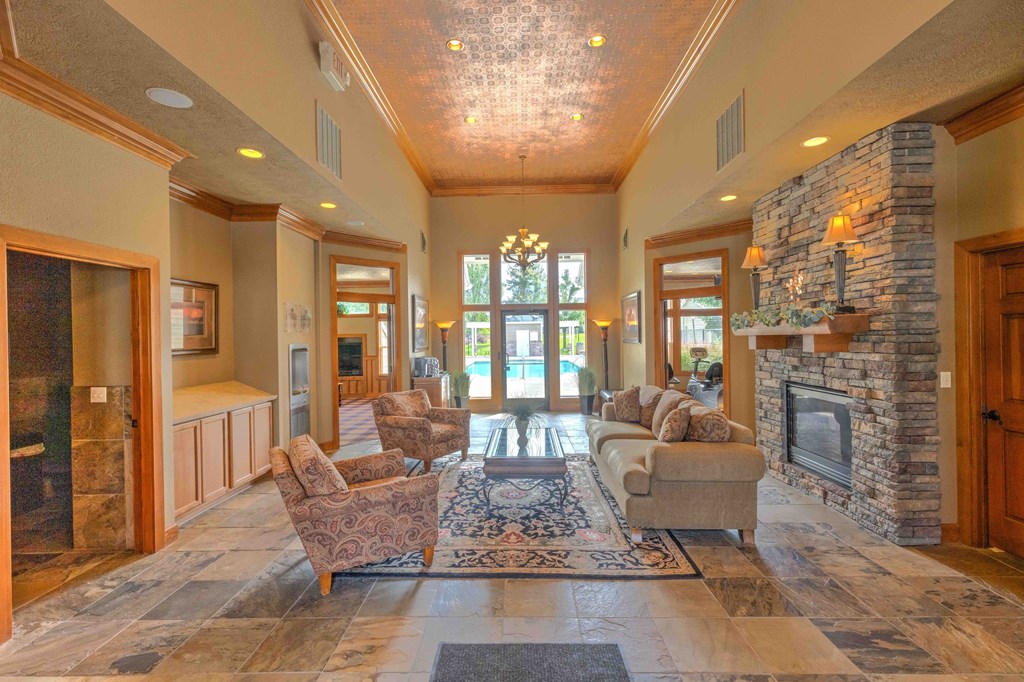 a large living room with a fireplace and couches