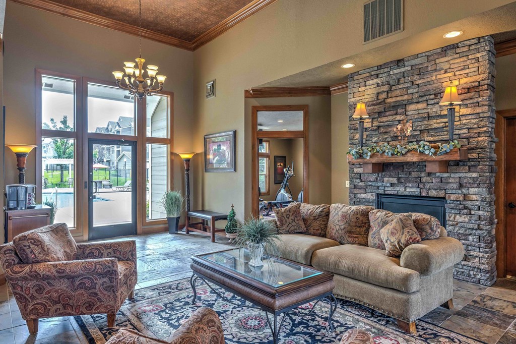 a large living room with a stone fireplace and a couch
