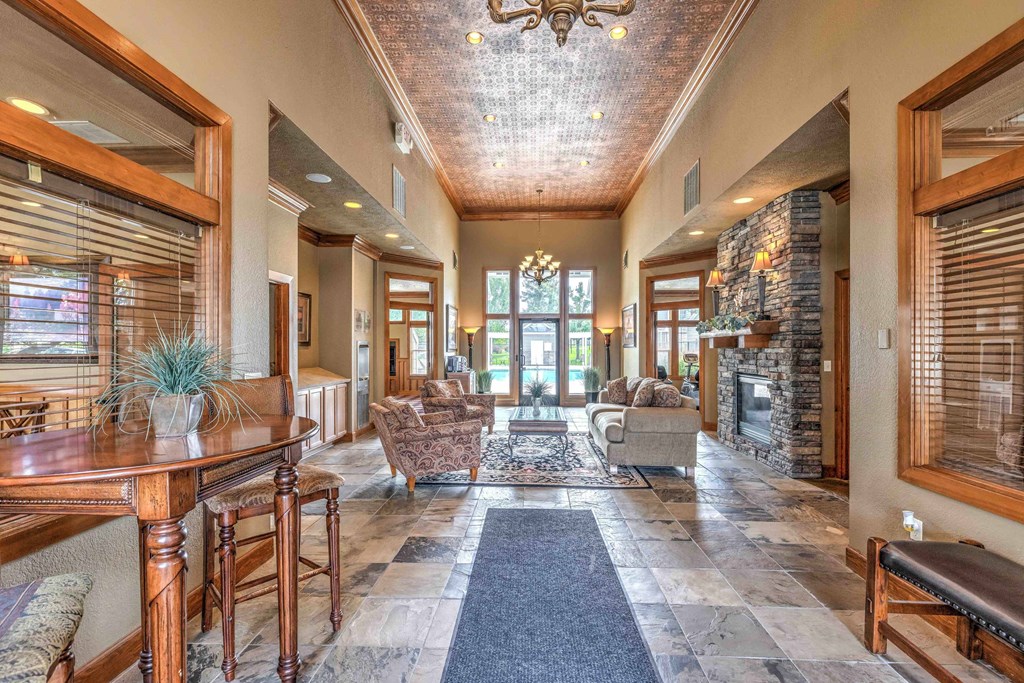 a large living room with a fireplace and a table