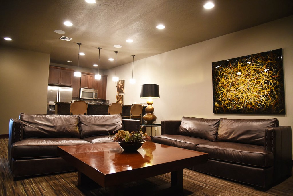 a living room with leather couches and a coffee table