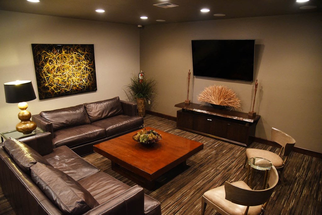 a living room with couches and a coffee table and a television