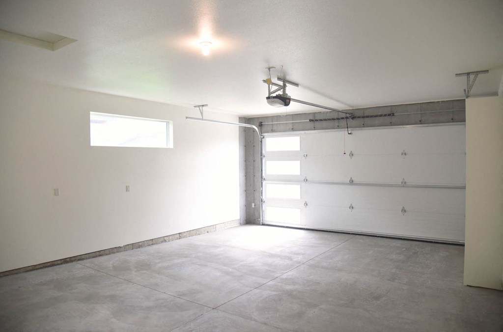 a garage with a white wall and a white garage door