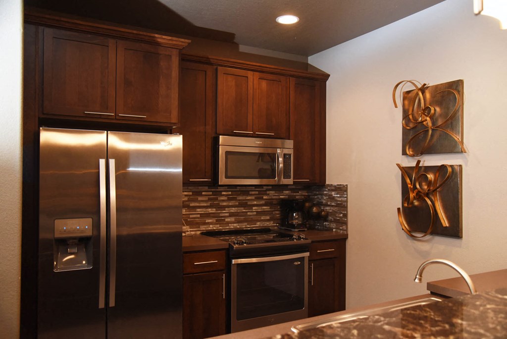a kitchen with stainless steel appliances and granite counter tops