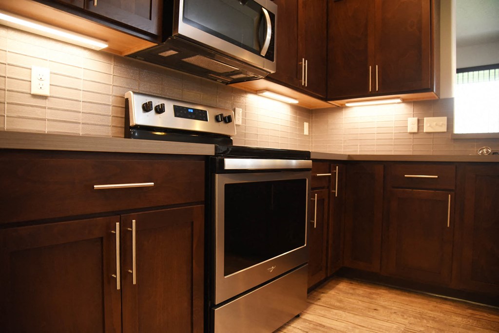 a kitchen with stainless steel appliances and wooden cabinets