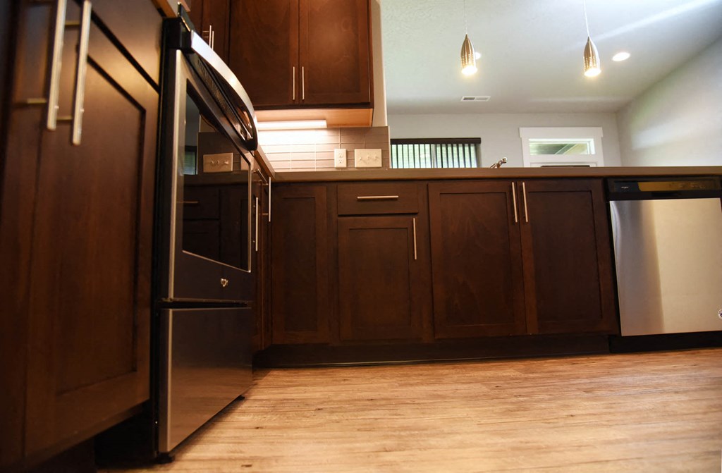 a kitchen with wooden cabinets and stainless steel appliances