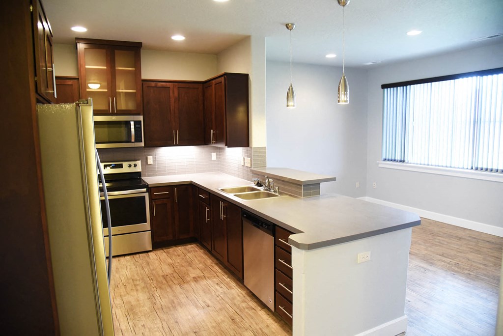 a kitchen with a large island and a refrigerator