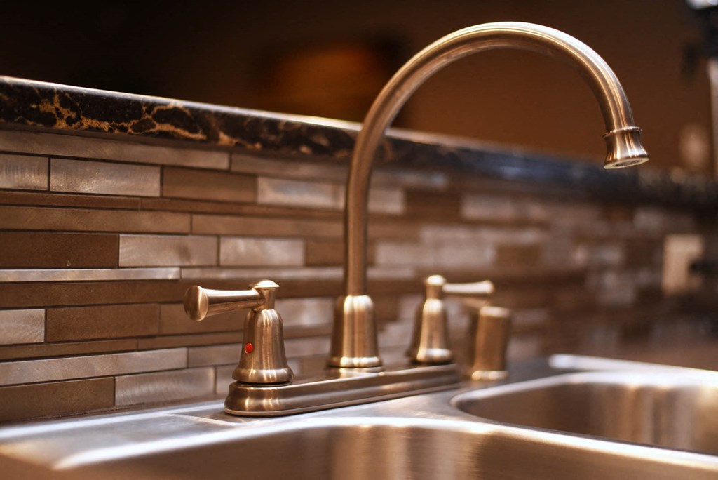 a close up of a kitchen sink with a faucet
