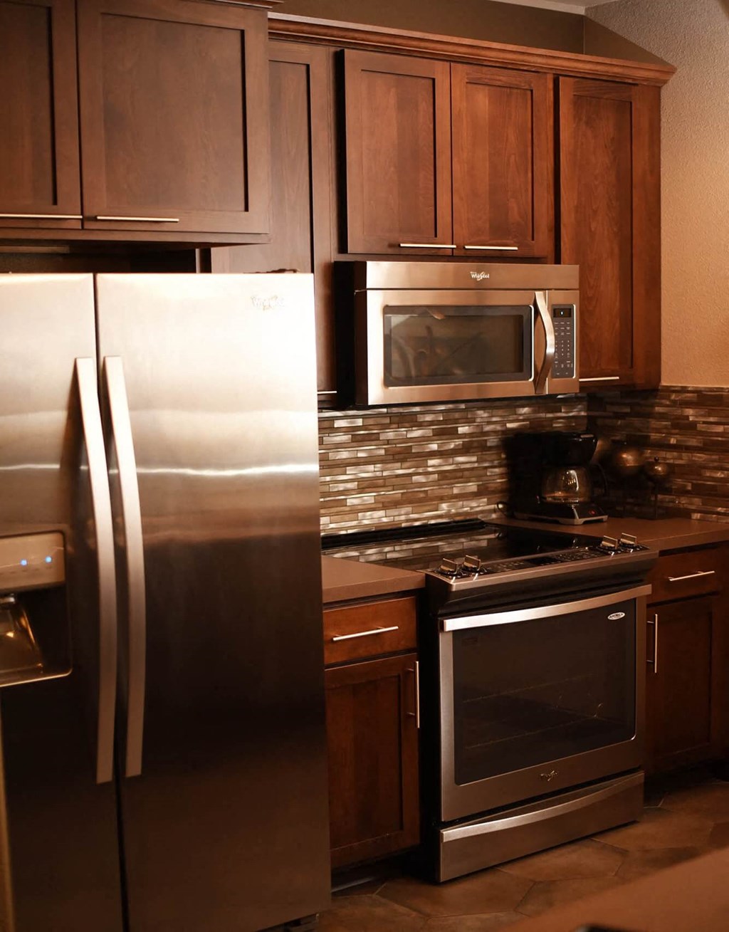 a kitchen with stainless steel appliances and wooden cabinets