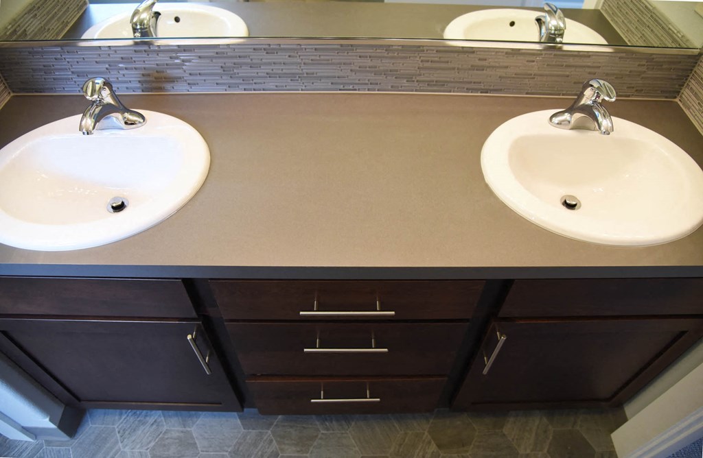 a bathroom with two sinks and a mirror