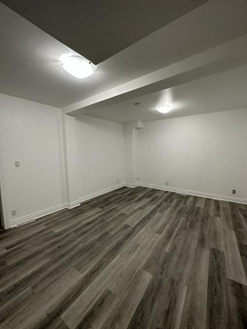 a living room with wooden floors and white walls