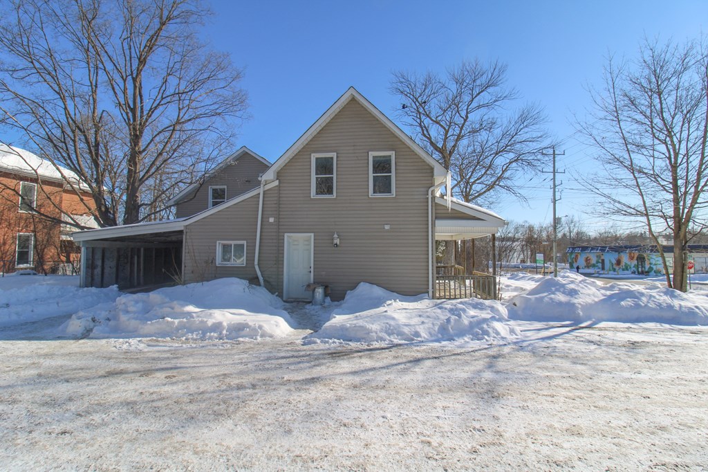 the front of the house with snow on the ground