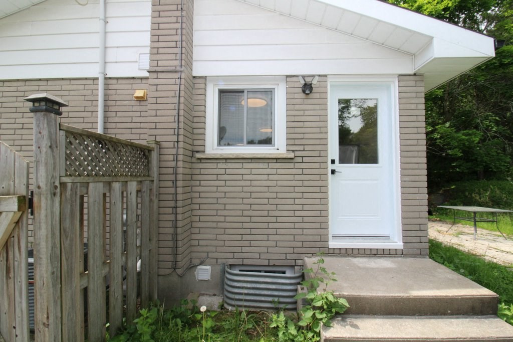 the front of a brick house with a white door