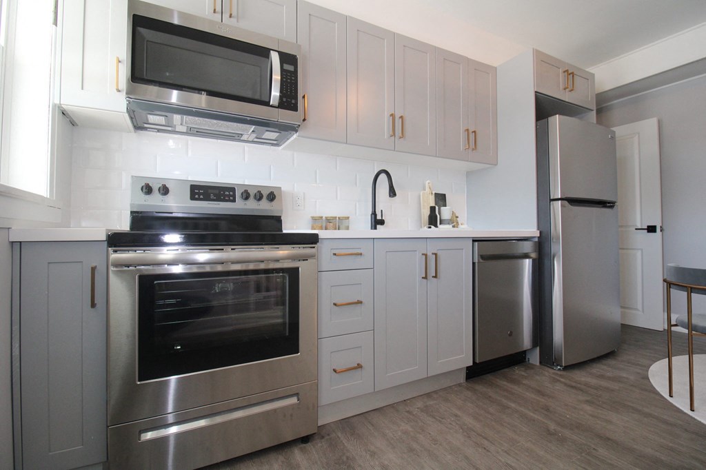 a kitchen with stainless steel appliances and white cabinets