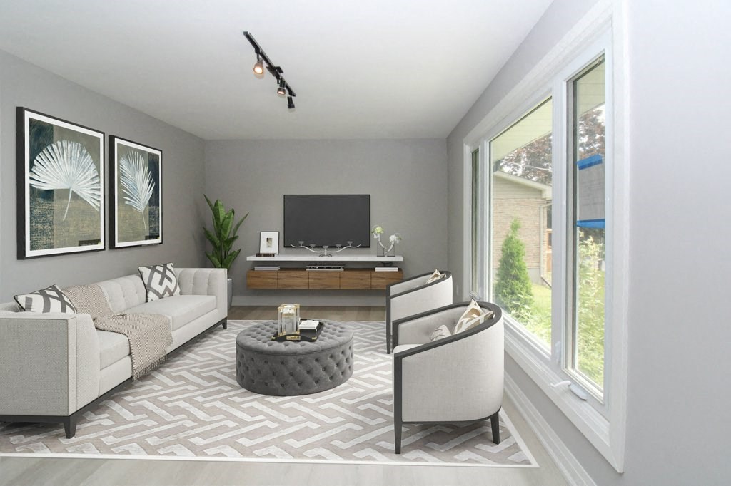 a living room with a couch and chairs and a television