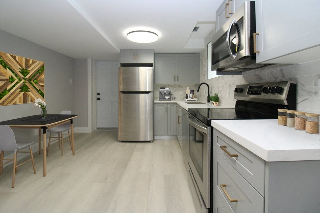 a kitchen with stainless steel appliances and a table and chairs
