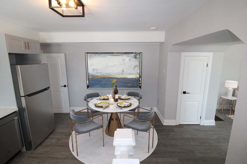 a kitchen and dining room with a table and chairs and a refrigerator