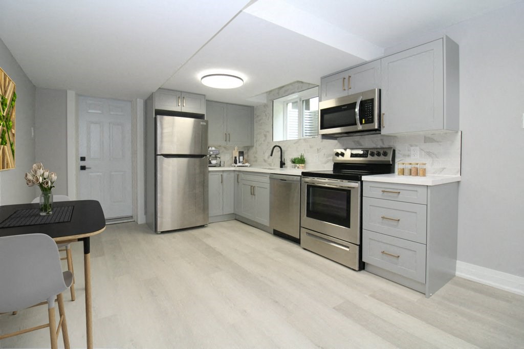 a kitchen with stainless steel appliances and white cabinets