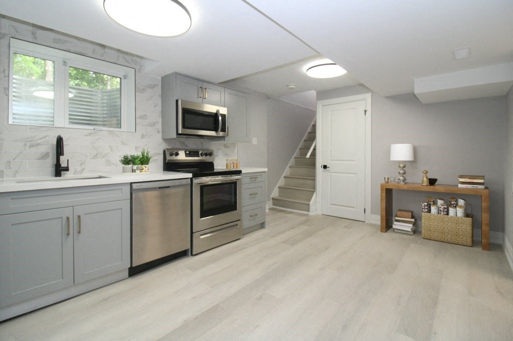 a kitchen with stainless steel appliances and white cabinets