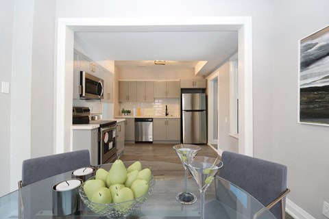 a kitchen and dining room with a glass table