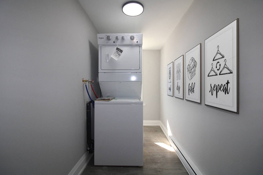 a washer and dryer in a small room in a room with a wall