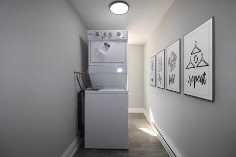 a washer and dryer in a small room in a room with a wall