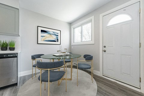 a dining room with a glass table and chairs