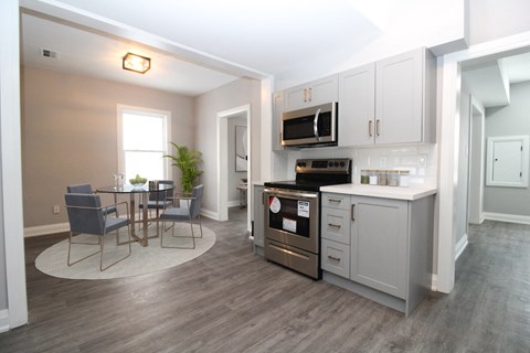 a kitchen and dining room with a table and chairs