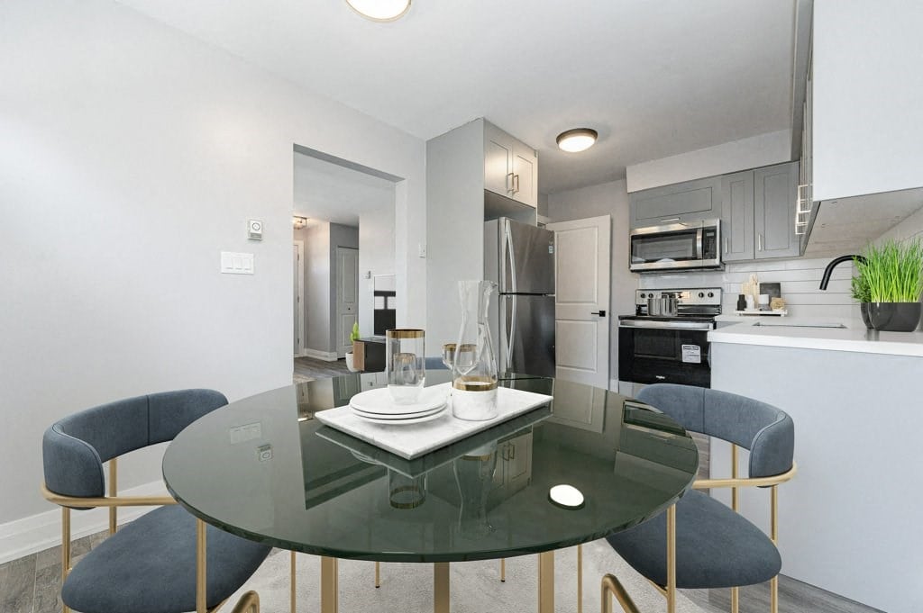 a kitchen and dining room with a glass table and chairs