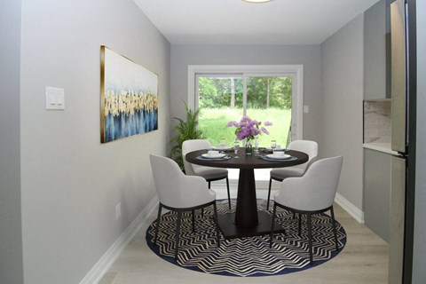 a dining room with a table and chairs and a window