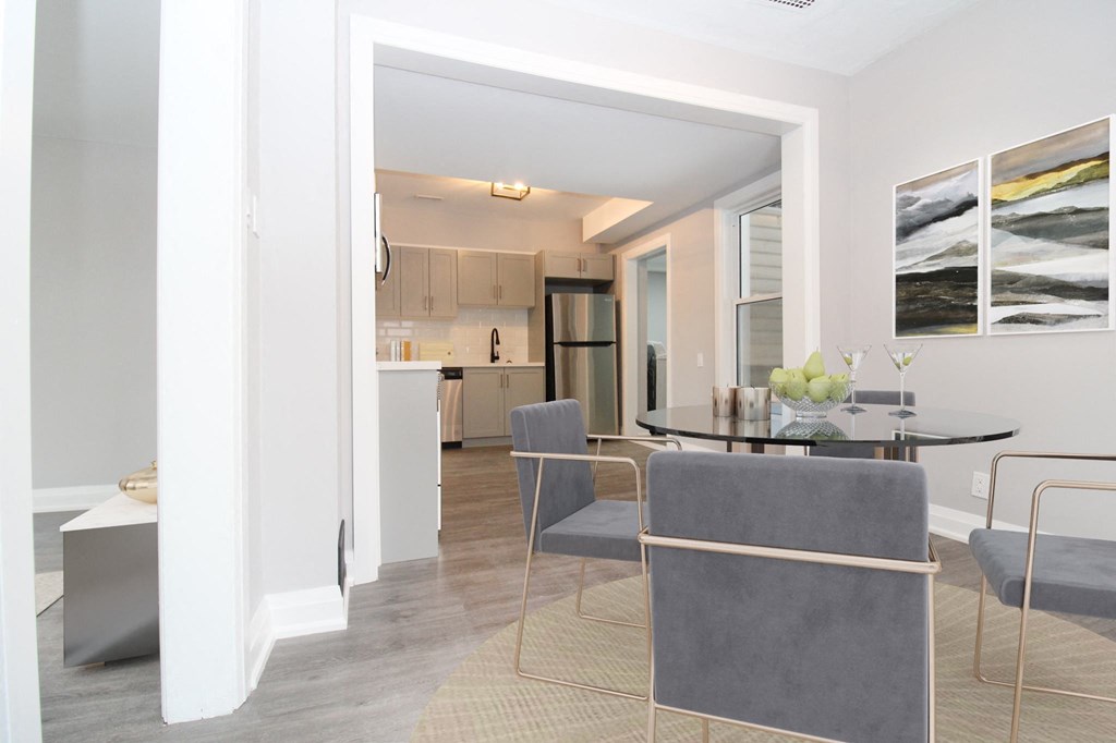 a living room and dining room with a table and chairs