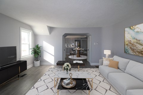 a living room with a white couch and a coffee table