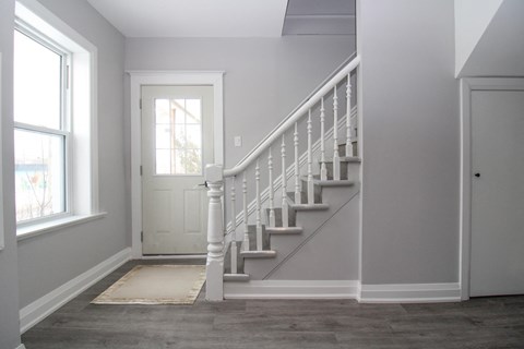 a staircase in a home with a white door and a stairwell