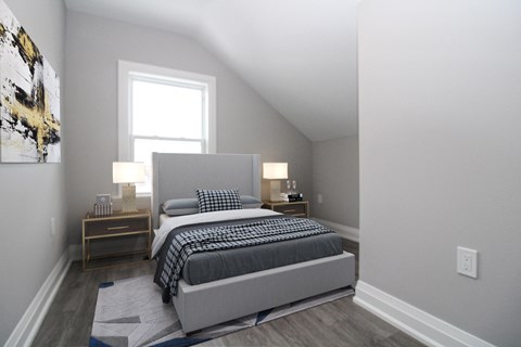 a bedroom with a bed and a window