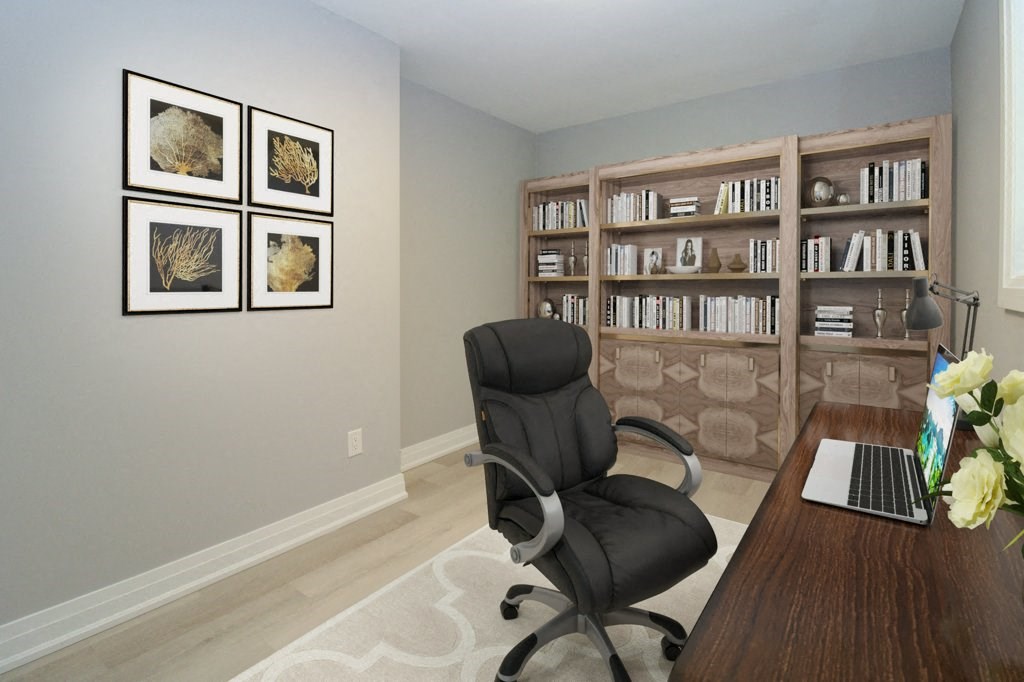 a home office with a black chair and a desk with a laptop