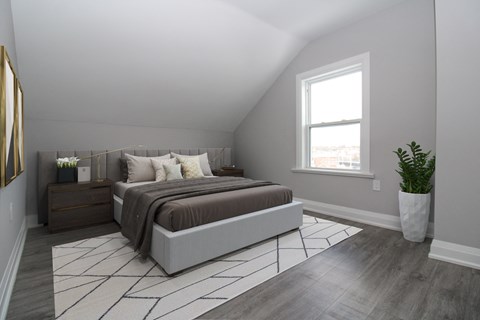 an attic bedroom with a bed and a window
