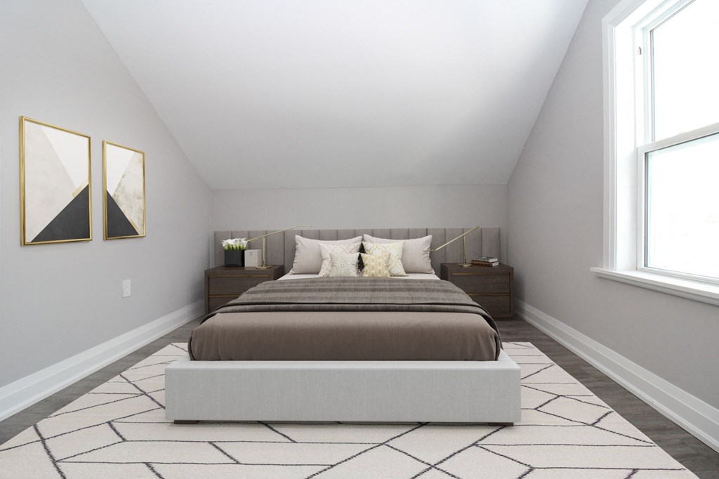 a bedroom with a bed and two windows