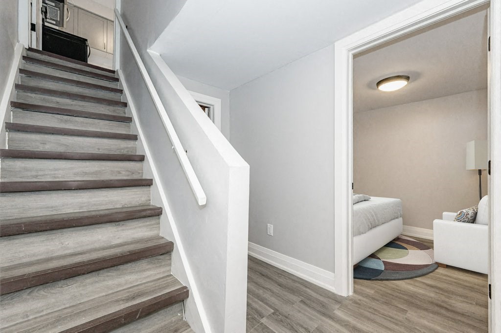 a staircase in a home with wood floors and white walls