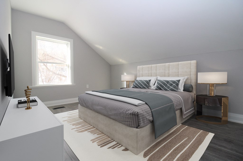 a bedroom with a bed and a desk and a window