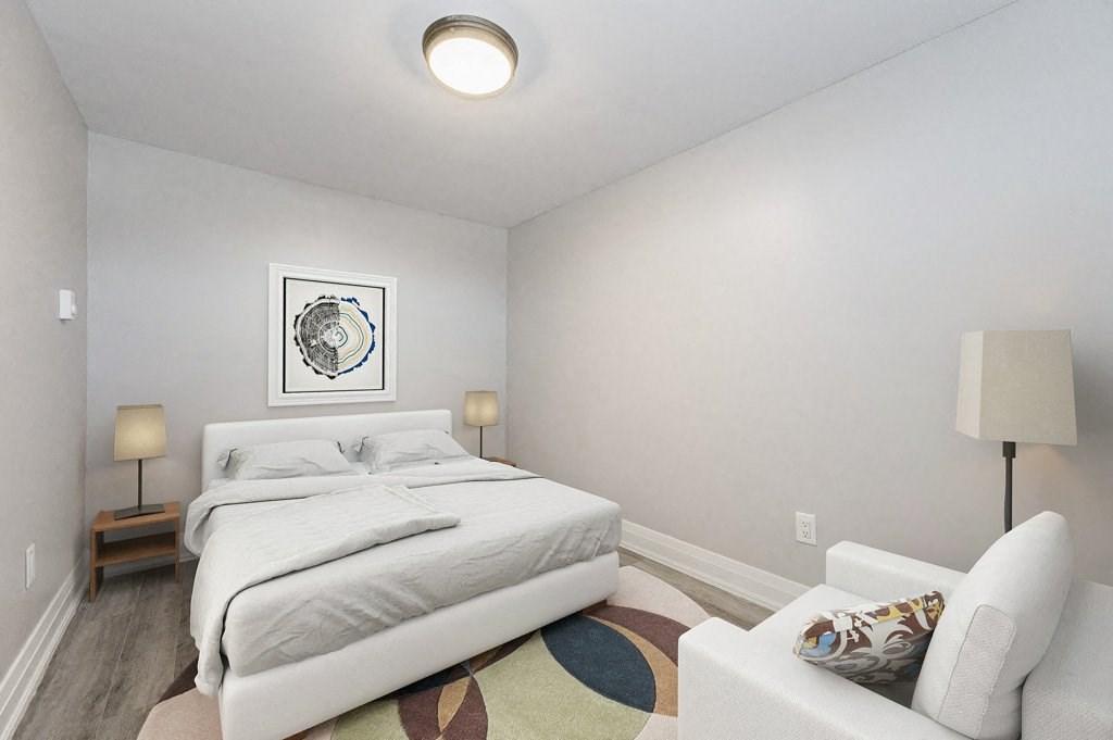 a bedroom with a white bed and a white couch