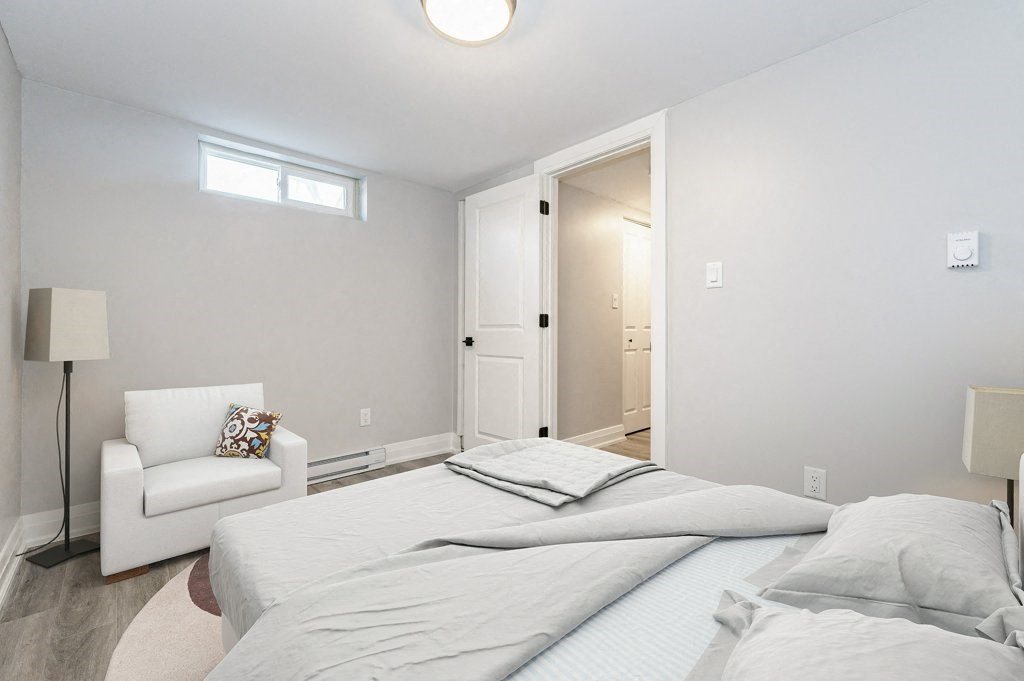 a bedroom with a bed and a chair and a closet