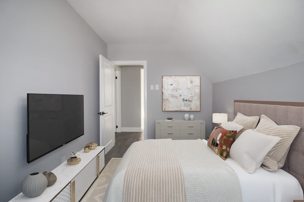 a bedroom with a large bed and a tv